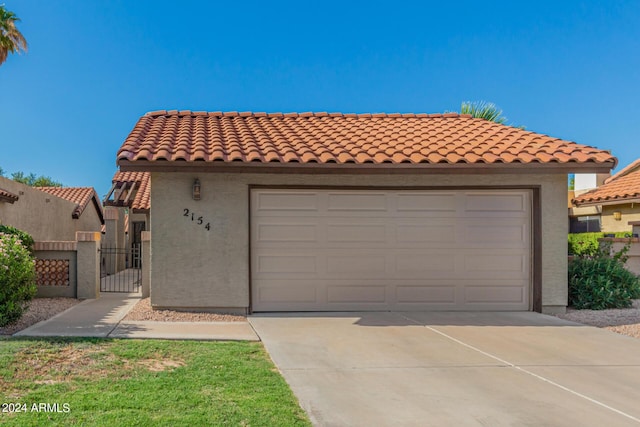 2154 E Forge Ave, Mesa, AZ 85204 - mediterranean / spanish-style home featuring driveway, a gate, a tiled roof, and stucco siding