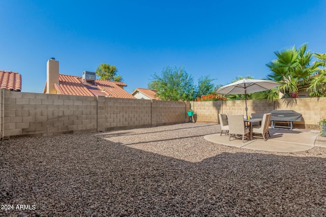 2154 E Forge Ave, Mesa, AZ 85204 - fenced backyard with a patio and central AC unit