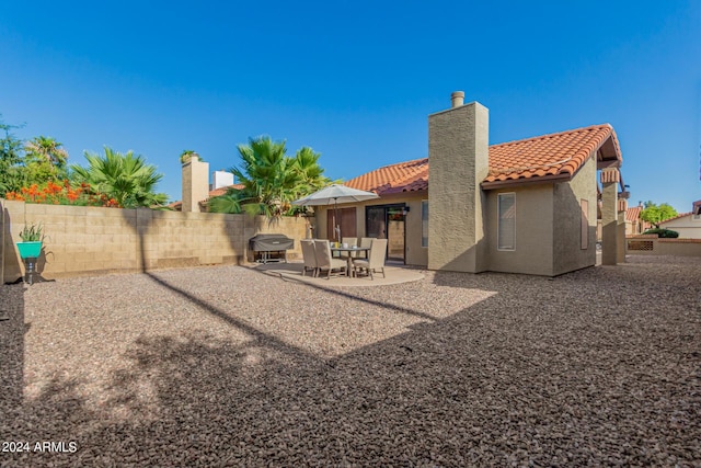 2154 E Forge Ave, Mesa, AZ 85204 - rear view of house with a tile roof, a patio, stucco siding, and a chimney