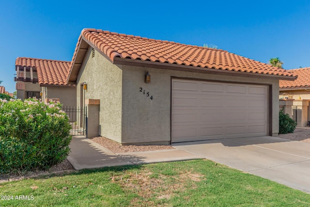2154 E Forge Ave, Mesa, AZ 85204 - mediterranean / spanish house with a garage, concrete driveway, stucco siding, and a tiled roof