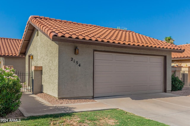 2154 E Forge Ave, Mesa, AZ 85204 - view of front of home with a garage, stucco siding, driveway, and a tiled roof