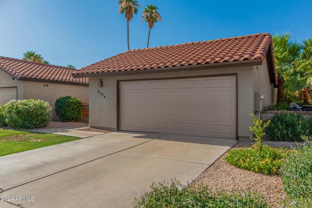 2154 E Forge Ave, Mesa, AZ 85204 - mediterranean / spanish-style home with stucco siding, a tiled roof, and driveway