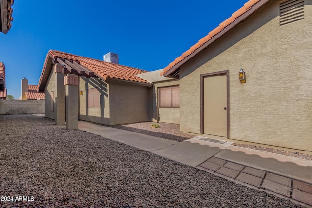 2154 E Forge Ave, Mesa, AZ 85204 - entrance to property featuring a tile roof, stucco siding, and a chimney
