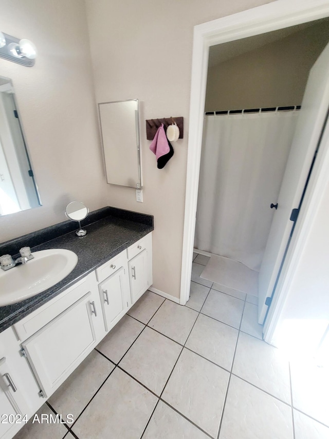 bathroom with tile patterned flooring and vanity