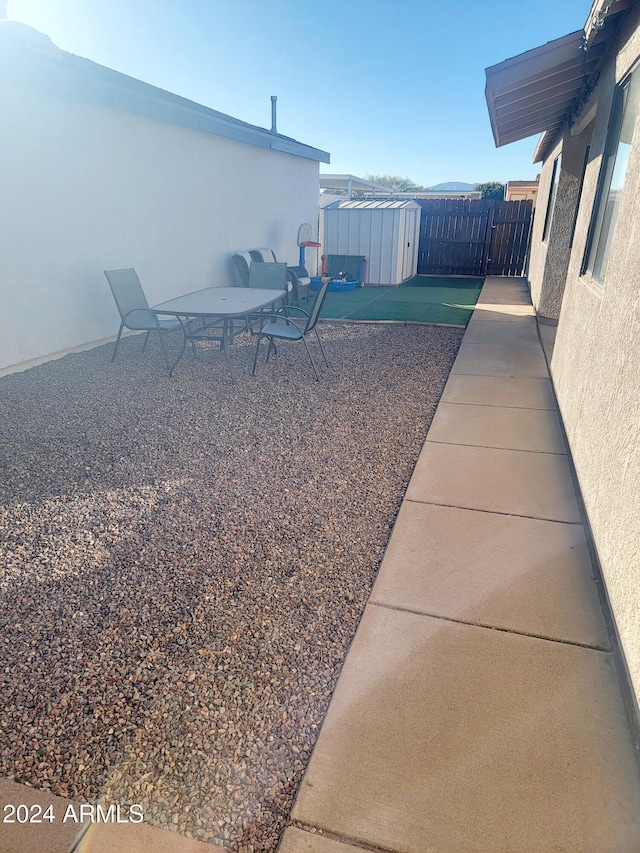 view of yard featuring a patio area and a shed