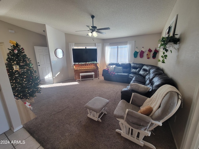 living room with ceiling fan, light carpet, and a textured ceiling