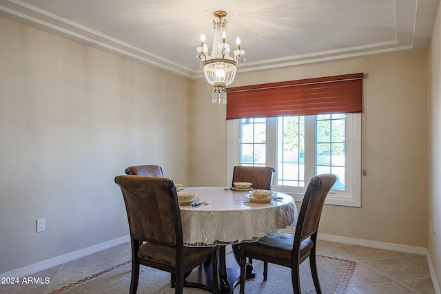 tiled dining room with a chandelier