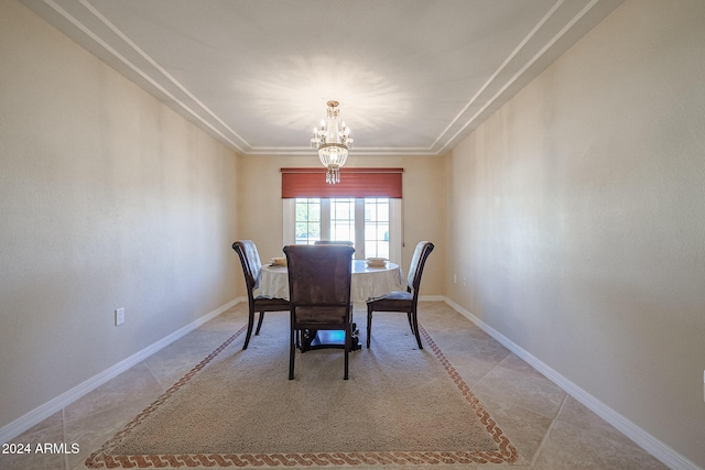 dining area with light tile patterned flooring, ornamental molding, and an inviting chandelier