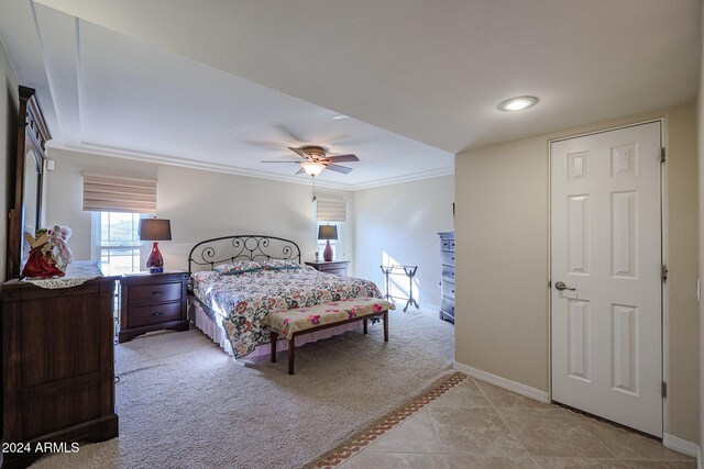 tiled bedroom with ceiling fan and ornamental molding