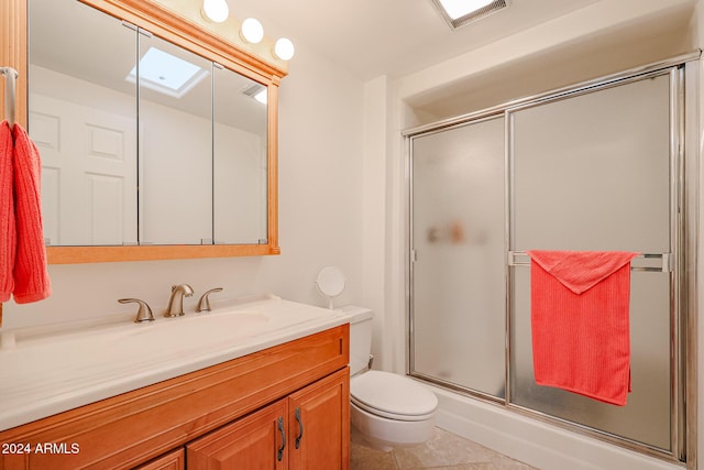 bathroom with tile patterned floors, vanity, toilet, and walk in shower