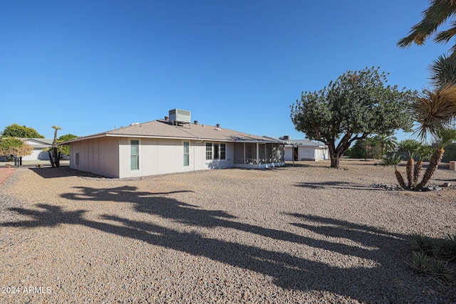 back of property with a sunroom and cooling unit