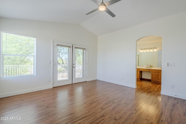 31259 N 42nd Pl, Cave Creek, AZ 85331 - empty room with arched walkways, healthy amount of natural light, vaulted ceiling, and wood finished floors
