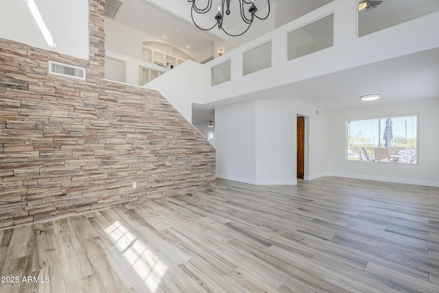 31259 N 42nd Pl, Cave Creek, AZ 85331 - unfurnished living room with wood finished floors, a high ceiling, and a chandelier