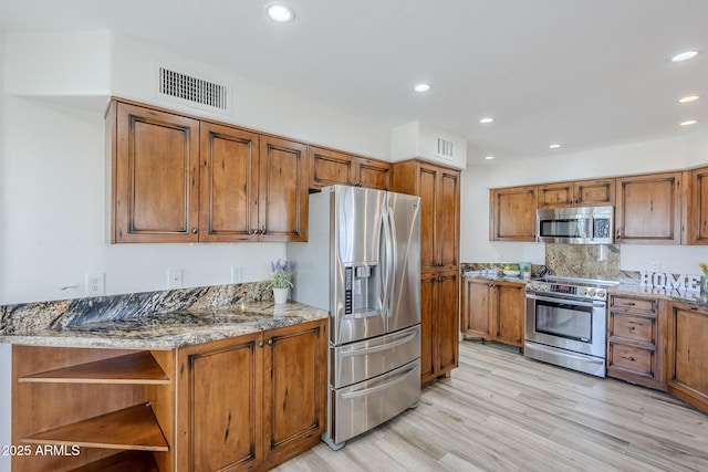 31259 N 42nd Pl, Cave Creek, AZ 85331 - kitchen with appliances with stainless steel finishes, brown cabinets, light wood-type flooring, open shelves, and recessed lighting