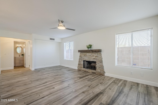 31259 N 42nd Pl, Cave Creek, AZ 85331 - unfurnished living room featuring ceiling fan, light wood-style floors, and a stone fireplace