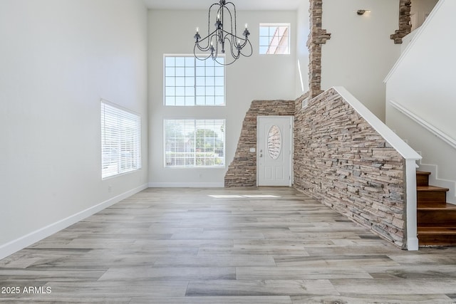 31259 N 42nd Pl, Cave Creek, AZ 85331 - unfurnished living room featuring stairs, a chandelier, a high ceiling, and wood finished floors