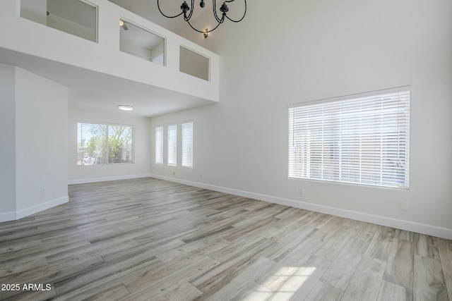 31259 N 42nd Pl, Cave Creek, AZ 85331 - empty room featuring a chandelier, wood finished floors, and a towering ceiling