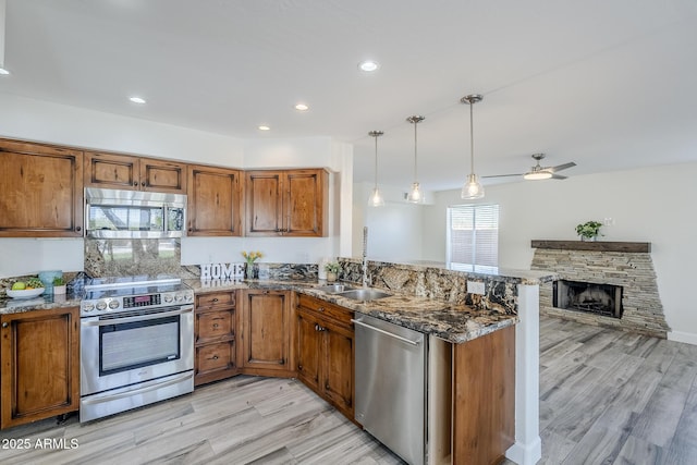 31259 N 42nd Pl, Cave Creek, AZ 85331 - kitchen featuring appliances with stainless steel finishes, brown cabinets, a peninsula, light wood-style floors, and recessed lighting