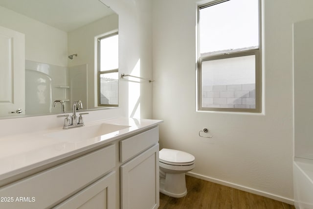 full bathroom with shower / bathing tub combination, vanity, hardwood / wood-style flooring, and toilet