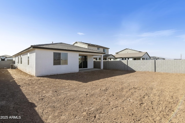 back of property featuring central AC