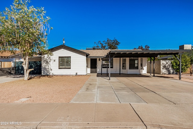 ranch-style home featuring a carport