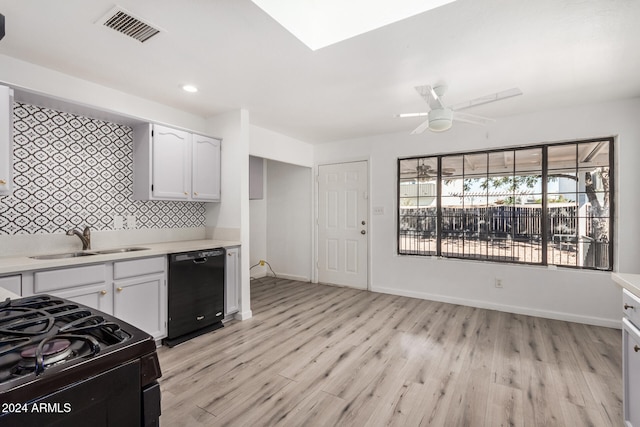 kitchen featuring ceiling fan, sink, black appliances, light hardwood / wood-style floors, and white cabinetry