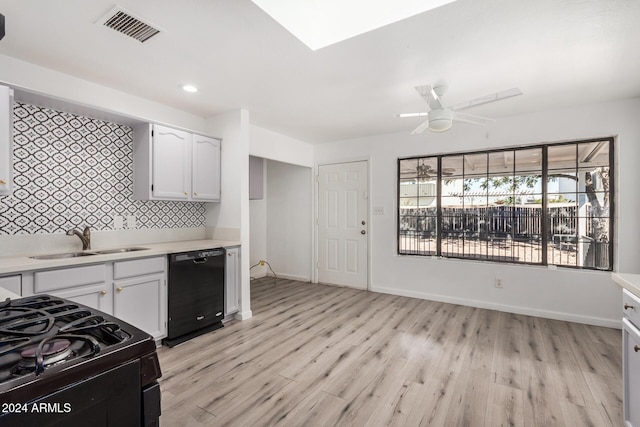 1818 E Monterey Way, Phoenix, AZ 85016 - kitchen featuring black appliances, light countertops, light wood-type flooring, white cabinets, and ceiling fan