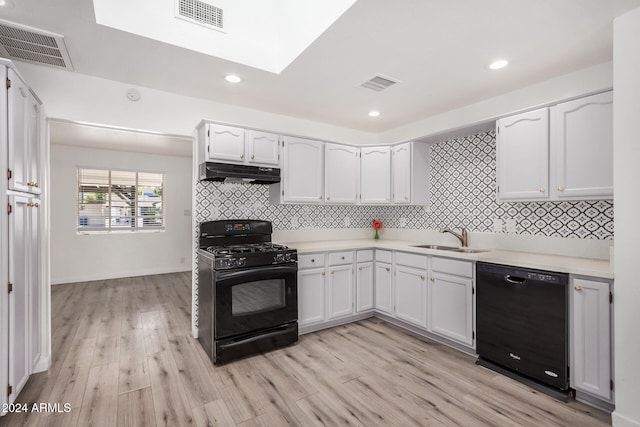 kitchen with black appliances, white cabinetry, light wood-type flooring, and sink