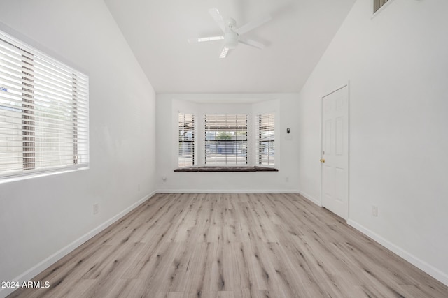 spare room with ceiling fan, light hardwood / wood-style floors, and lofted ceiling