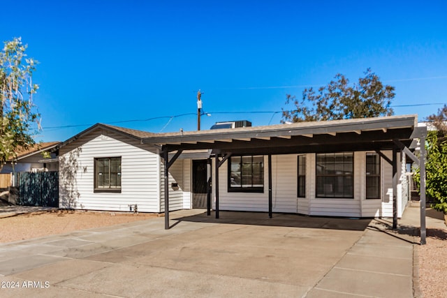 single story home featuring a carport