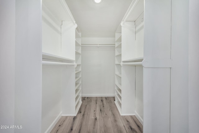 walk in closet with light wood-type flooring