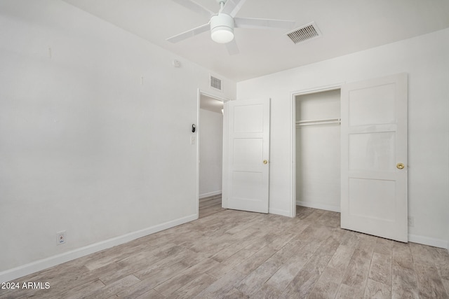 unfurnished bedroom featuring ceiling fan, light hardwood / wood-style floors, and a closet