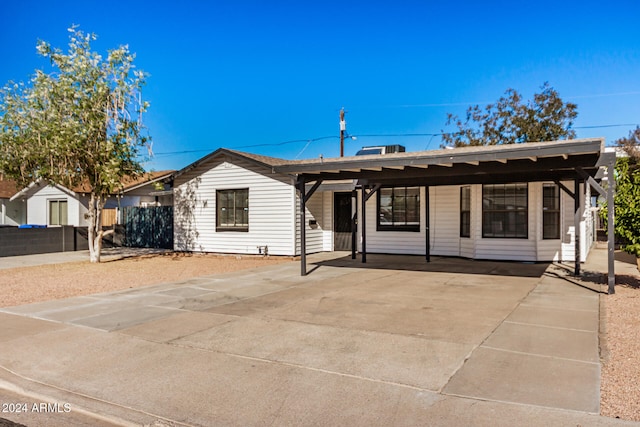 ranch-style home featuring a carport