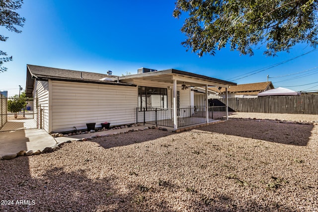 back of property with ceiling fan and a patio area