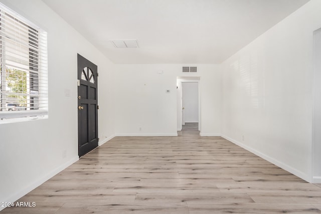 empty room with light hardwood / wood-style floors