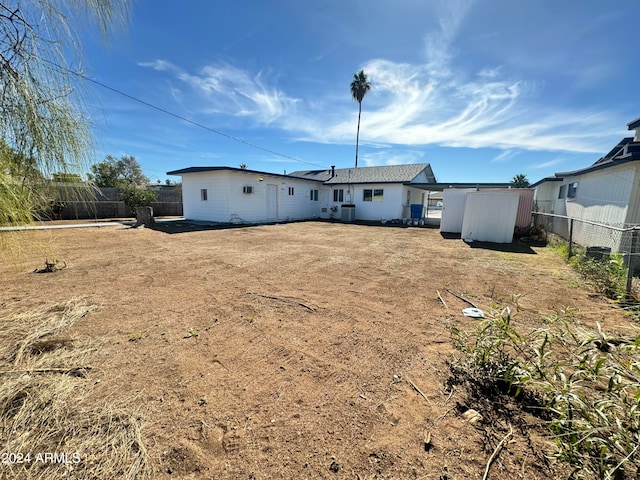 rear view of property with a shed