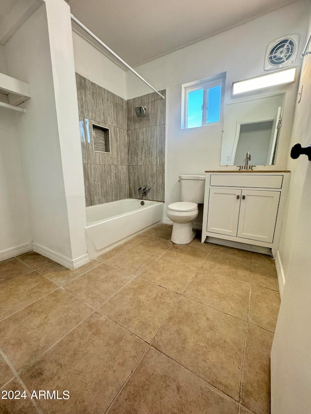 full bathroom featuring tiled shower / bath combo, tile floors, toilet, and vanity