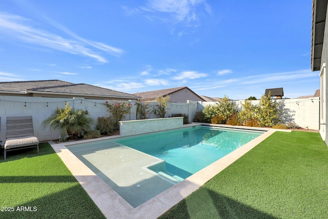 view of pool with a lawn