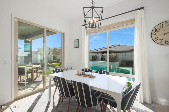 dining room featuring a healthy amount of sunlight and a notable chandelier