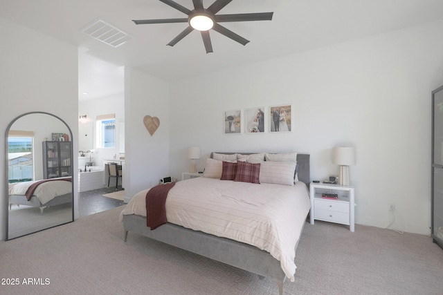 bedroom featuring ensuite bathroom, carpet flooring, and ceiling fan