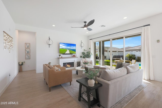 living room featuring ceiling fan and light wood-type flooring