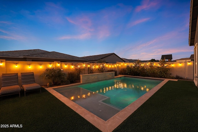 view of pool at dusk