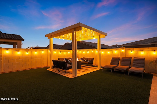 patio terrace at dusk featuring an outdoor hangout area