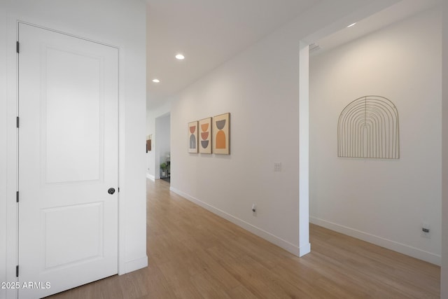 corridor with light hardwood / wood-style floors