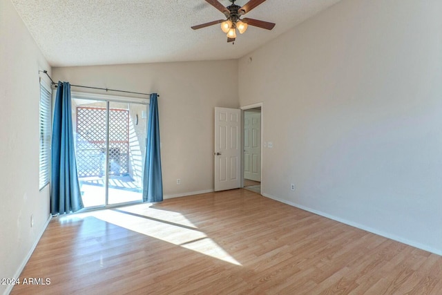 empty room featuring a textured ceiling, light hardwood / wood-style flooring, ceiling fan, and lofted ceiling