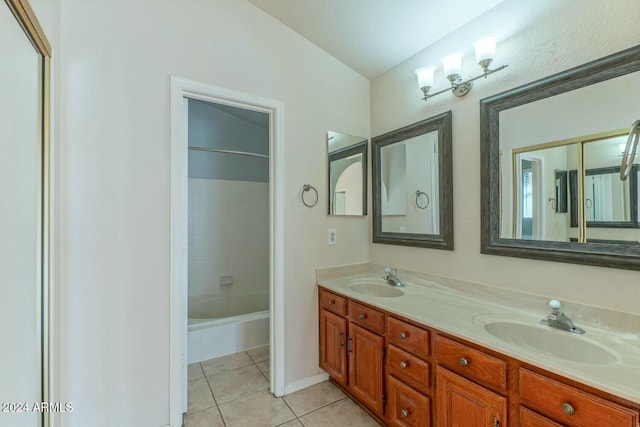 bathroom featuring tile patterned flooring, vanity, and lofted ceiling