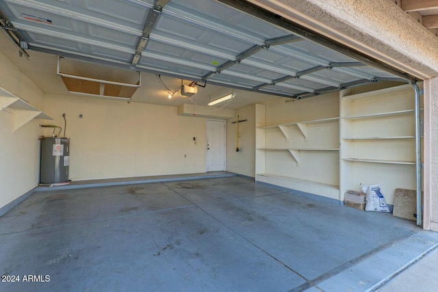 garage featuring electric water heater and a garage door opener