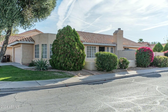 mediterranean / spanish house featuring a garage