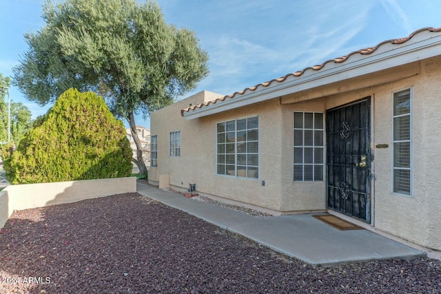 property entrance with a patio area