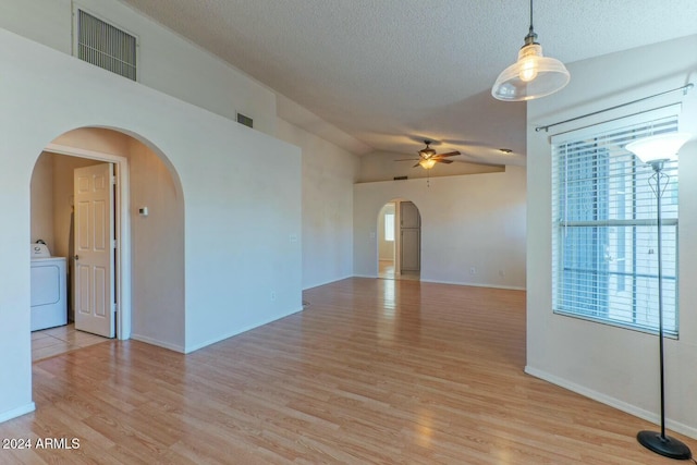 empty room featuring washer / dryer, a textured ceiling, light hardwood / wood-style flooring, and ceiling fan